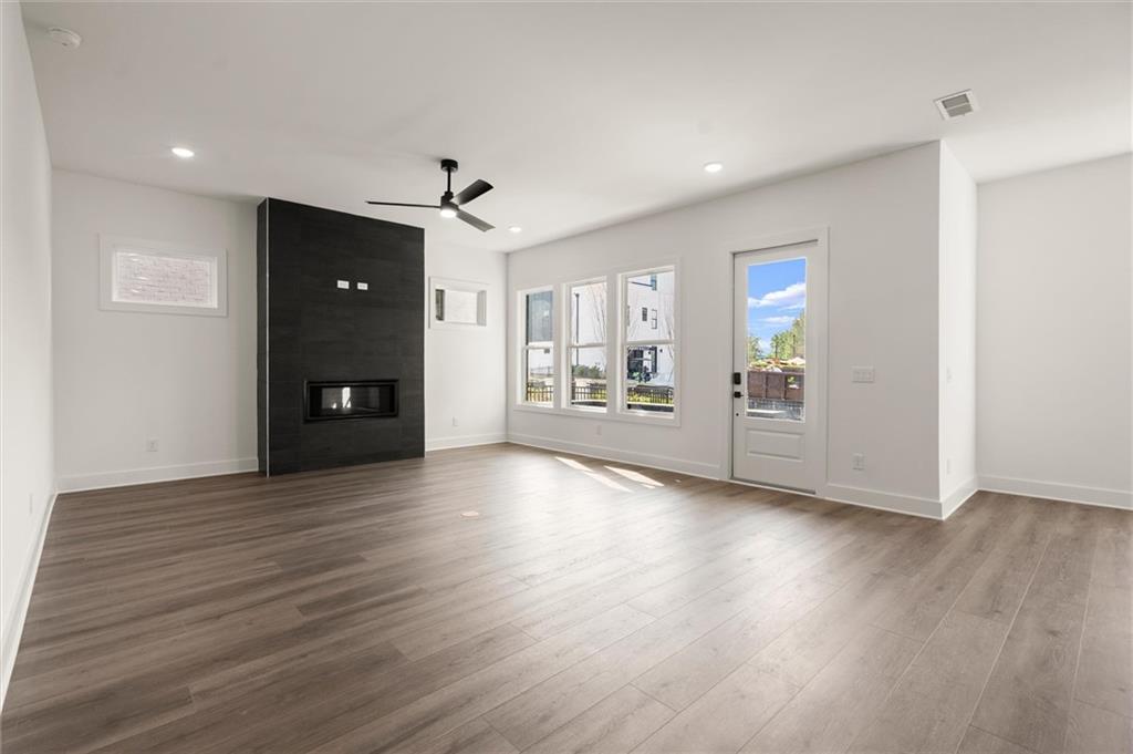 322 Treble Way Alpharetta, GA 30009 - Photo 6 of 67 an empty room with wooden floor and windows