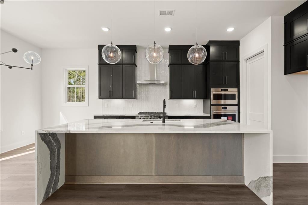 322 Treble Way Alpharetta, GA 30009 - Photo 9 of 67 a large kitchen with stainless steel appliances granite countertop a granite counter tops and a large window