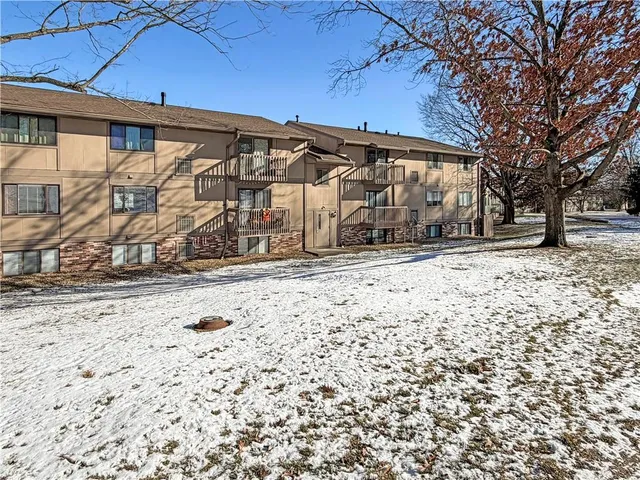 a wooden house with trees in the background