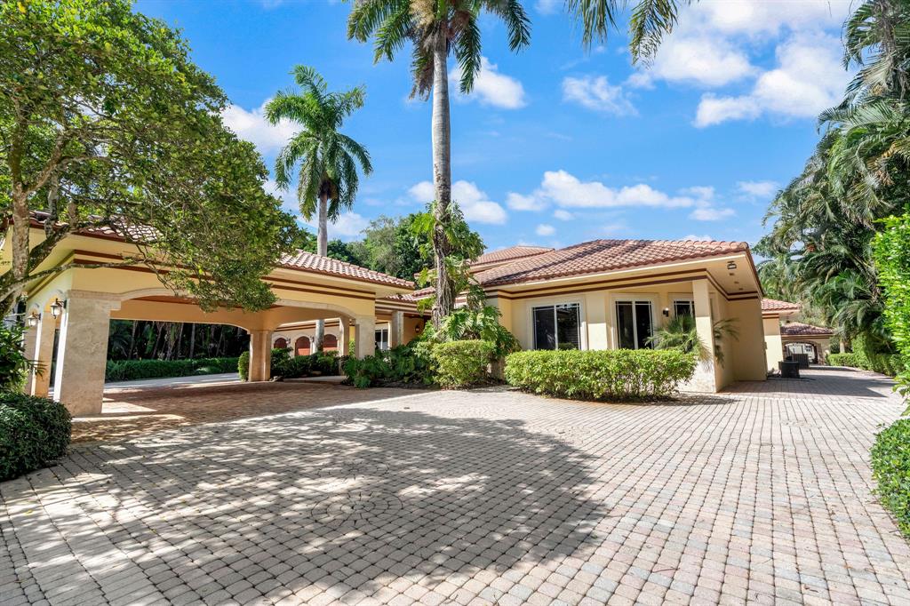 14641 Mustang Trail Southwest Ranches, FL 33330 - Photo 12 of 94 a front view of a house with a garden and entryway