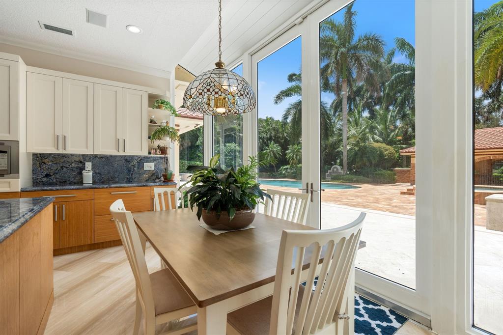 14641 Mustang Trail Southwest Ranches, FL 33330 - Photo 37 of 94 a dining room with furniture a chandelier and window