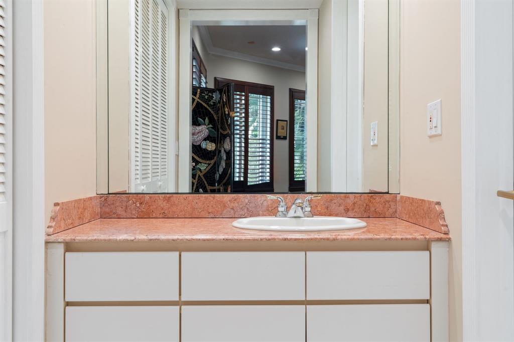 14641 Mustang Trail Southwest Ranches, FL 33330 - Photo 53 of 94 a bathroom with a sink and a mirror