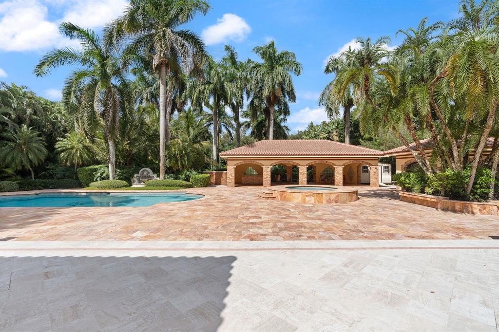 14641 Mustang Trail Southwest Ranches, FL 33330 - Photo 63 of 94 a front view of house with yard and trees around