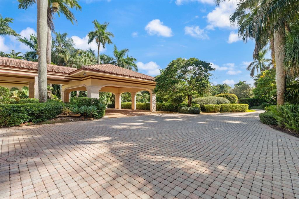 14641 Mustang Trail Southwest Ranches, FL 33330 - Photo 10 of 94 a front view of a house with a yard and potted plants