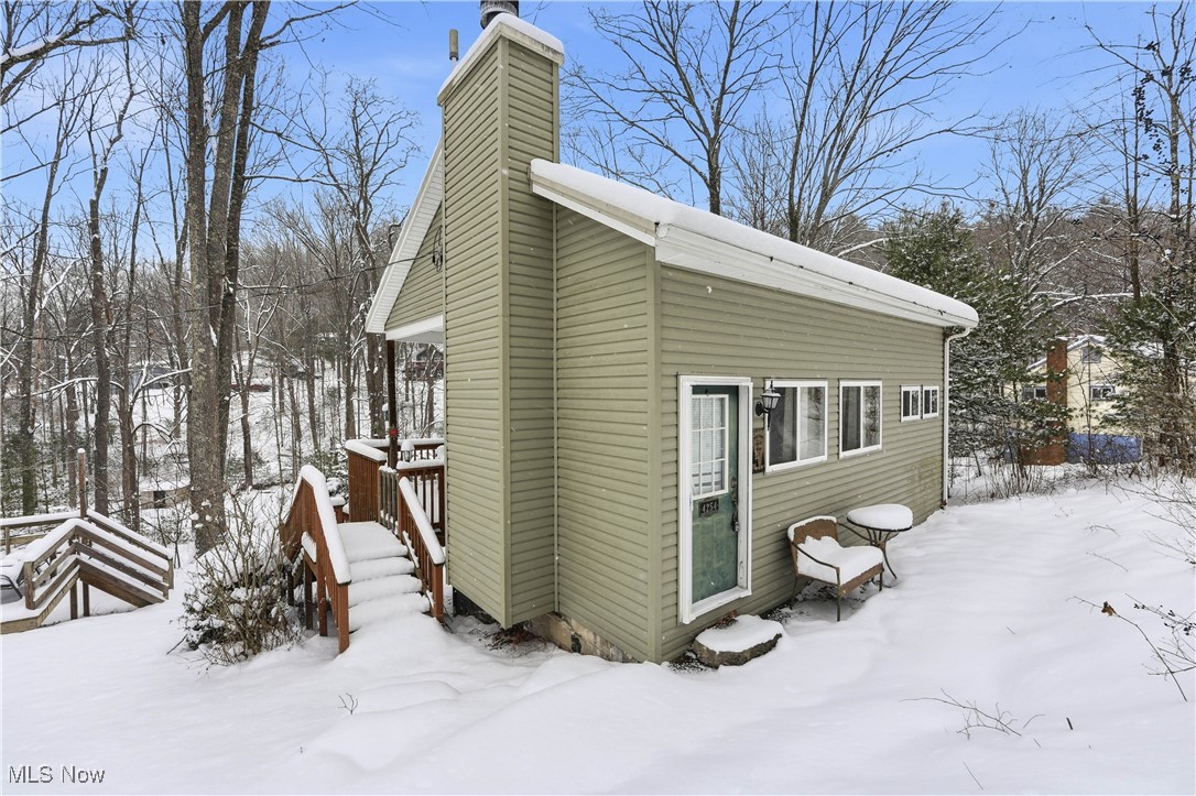 4254 Doral Road Southwest Carrollton, OH 44615 - Photo 4 of 46 Snow covered property featuring a chimney and a deck
