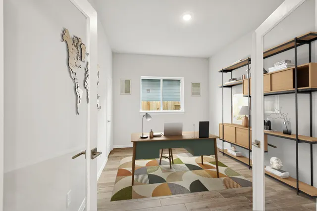 a living room with a couch and a table with wooden floor