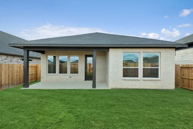 a view of an house with backyard space and balcony