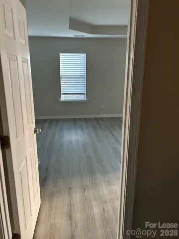 a view of a small space with wooden floor and a window