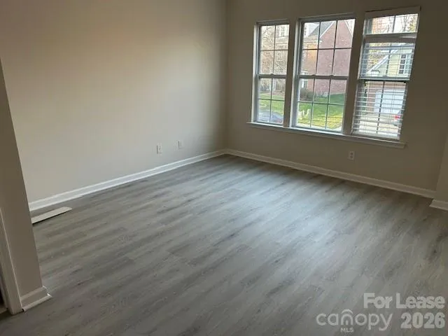 a bathroom with a granite countertop toilet and a sink