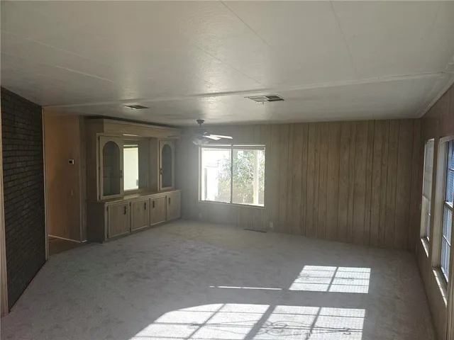 a view of a kitchen with white cabinets and wooden floor