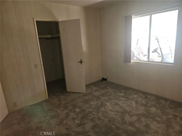 a view of a kitchen with white cabinets and wooden floor