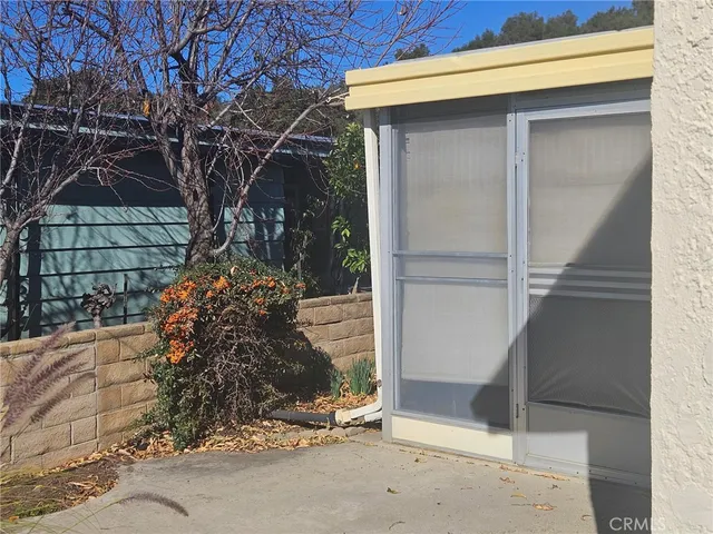 a side view of a house with a tree