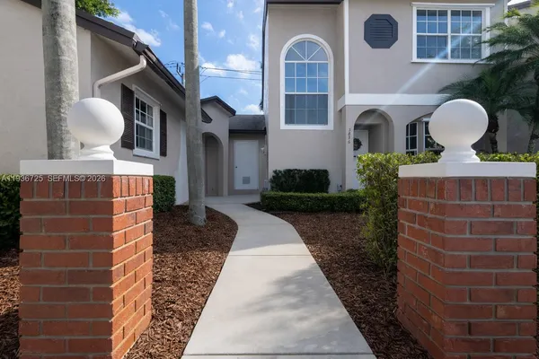a front view of a house with garden