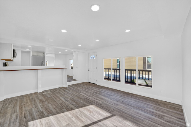 2491 Highway 89, Unit 523 Pleasant View, UT 84404 - Photo 8 of 31 Unfurnished living room featuring dark wood finished floors, recessed lighting, and plenty of natural light