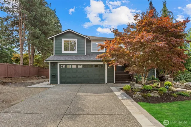a front view of a house with a yard and garage
