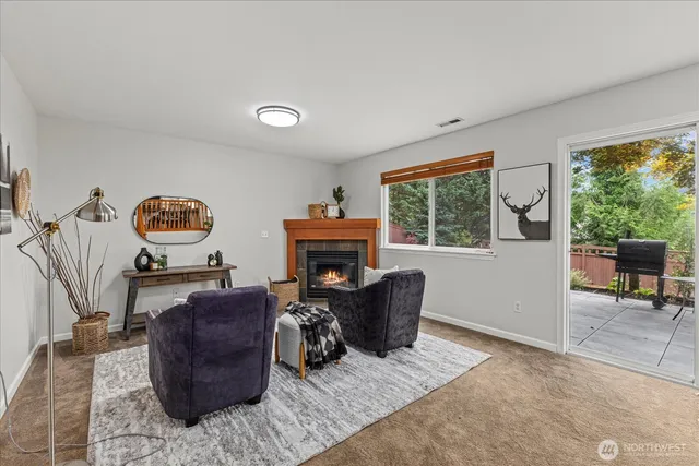 a living room with furniture a window and a fireplace
