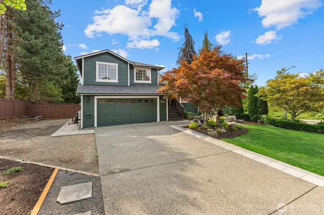 a view of a house with a yard and garage