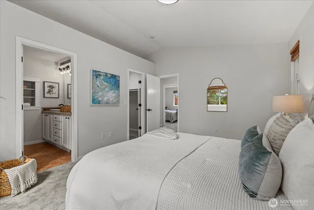 a bedroom with a bed and a view of kitchen