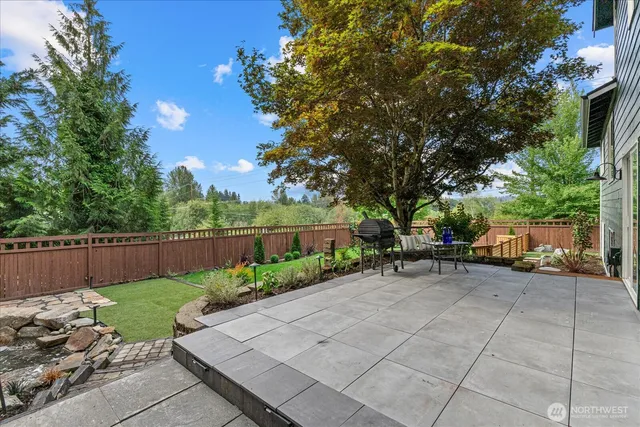 a view of a backyard with sitting area