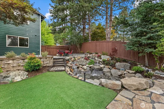 a view of a backyard with plants and a garden