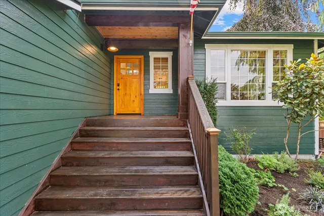 a view of a house with large windows and a table