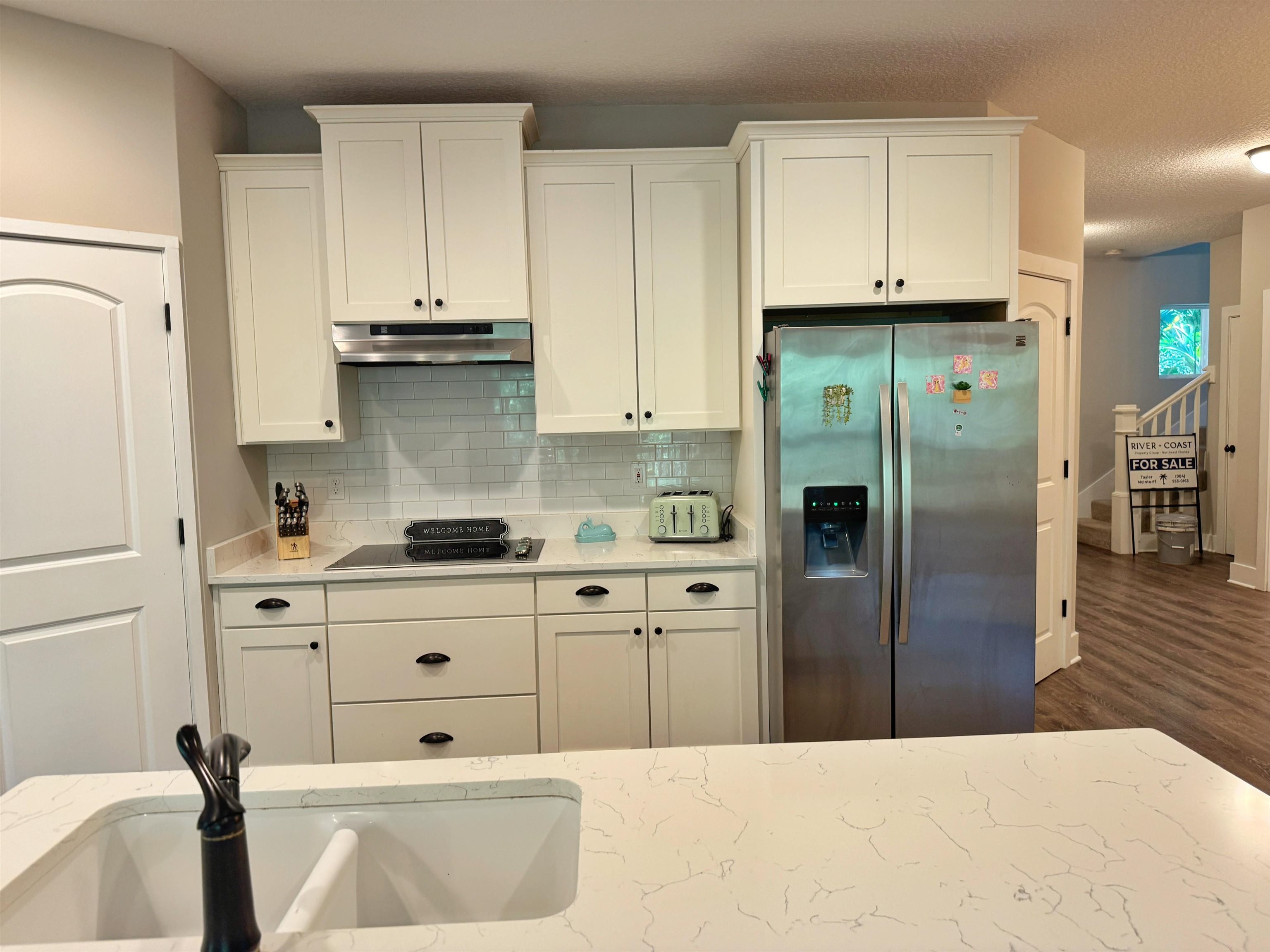 2523 Oleander Street St. Augustine, FL 32080 - Photo 12 of 54 a kitchen with stainless steel appliances a refrigerator sink and cabinets