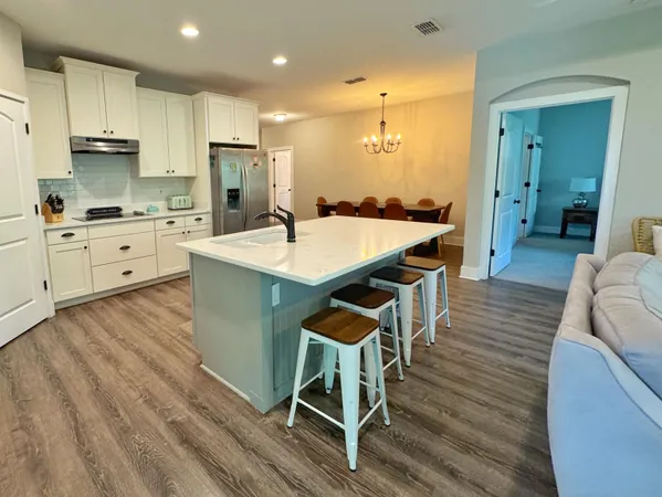 a large kitchen with kitchen island a island in the center