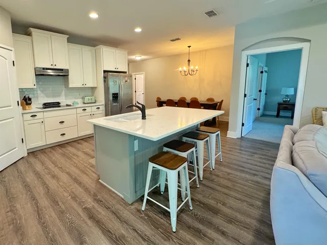 a large kitchen with kitchen island a island in the center