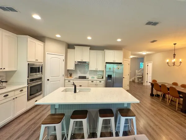 a large kitchen with a table and chairs