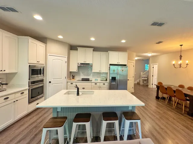 a large kitchen with a table and chairs