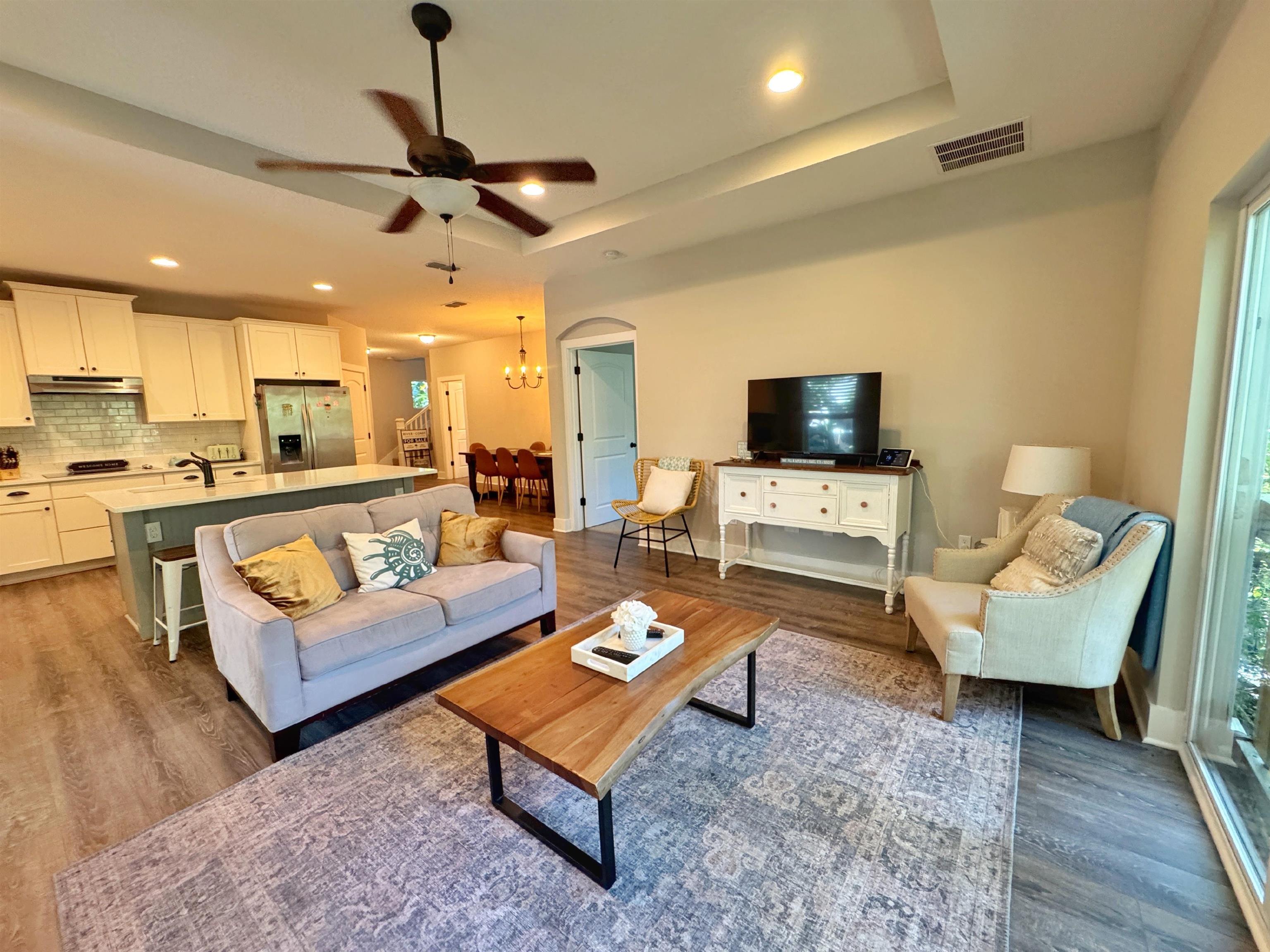 2523 Oleander Street St. Augustine, FL 32080 - Photo 23 of 54 a living room with furniture a flat screen tv and kitchen view