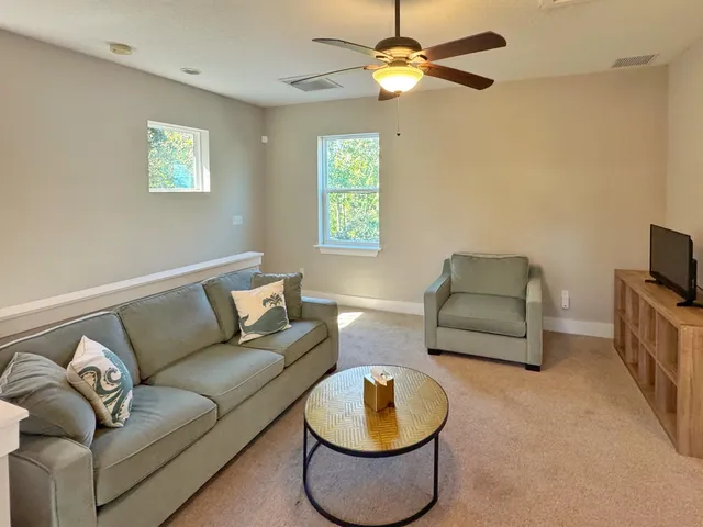 a view of an empty room with a cabinet and a flat screen tv