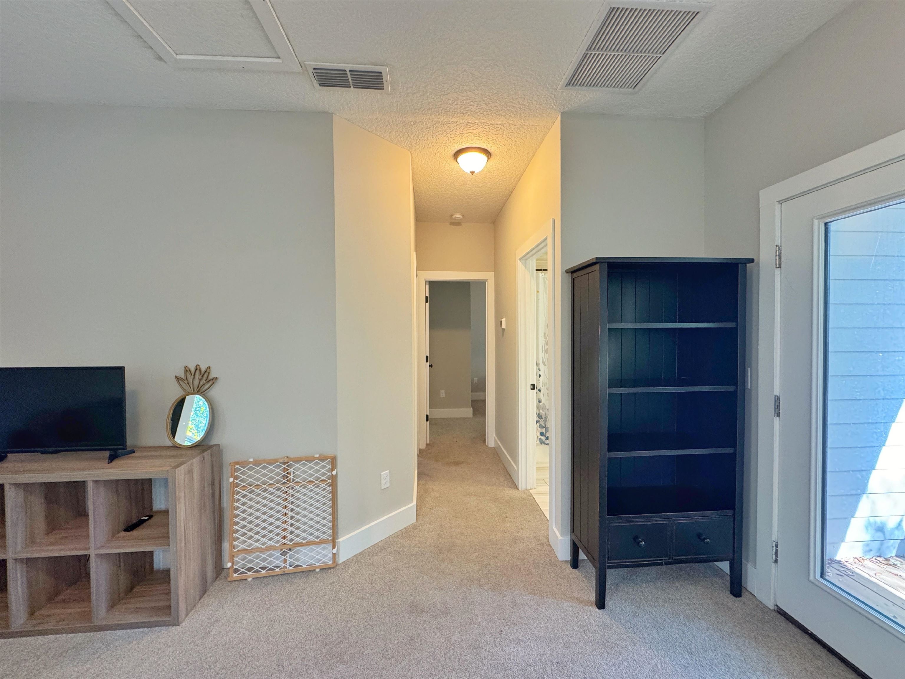 2523 Oleander Street St. Augustine, FL 32080 - Photo 46 of 54 a view of an empty room with a cabinet and a flat screen tv