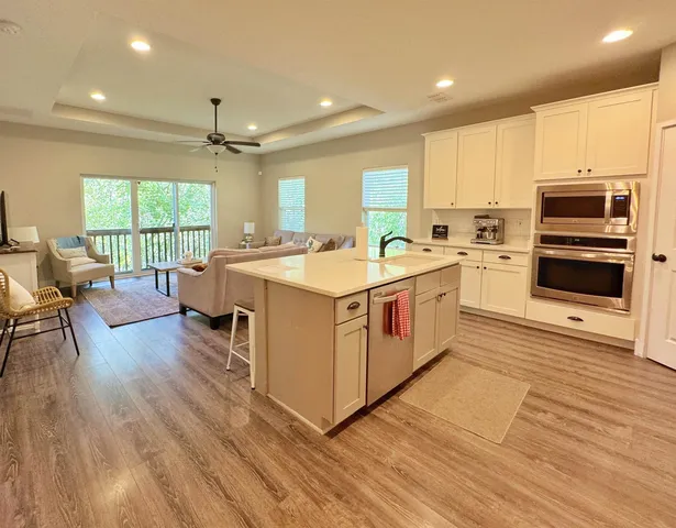a large white kitchen with a stove a sink and a refrigerator