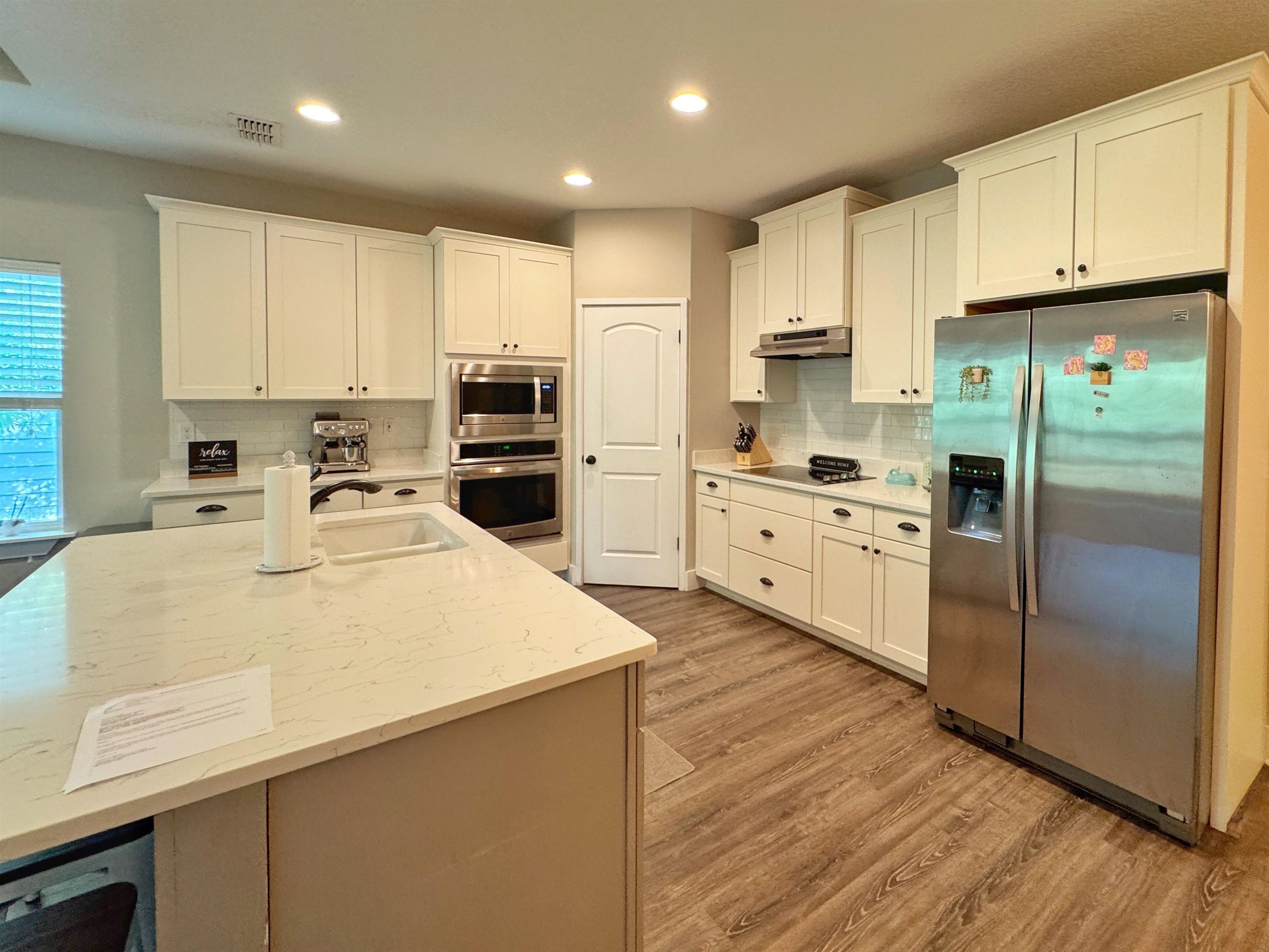 2523 Oleander Street St. Augustine, FL 32080 - Photo 8 of 54 a kitchen with stainless steel appliances a refrigerator sink and cabinets