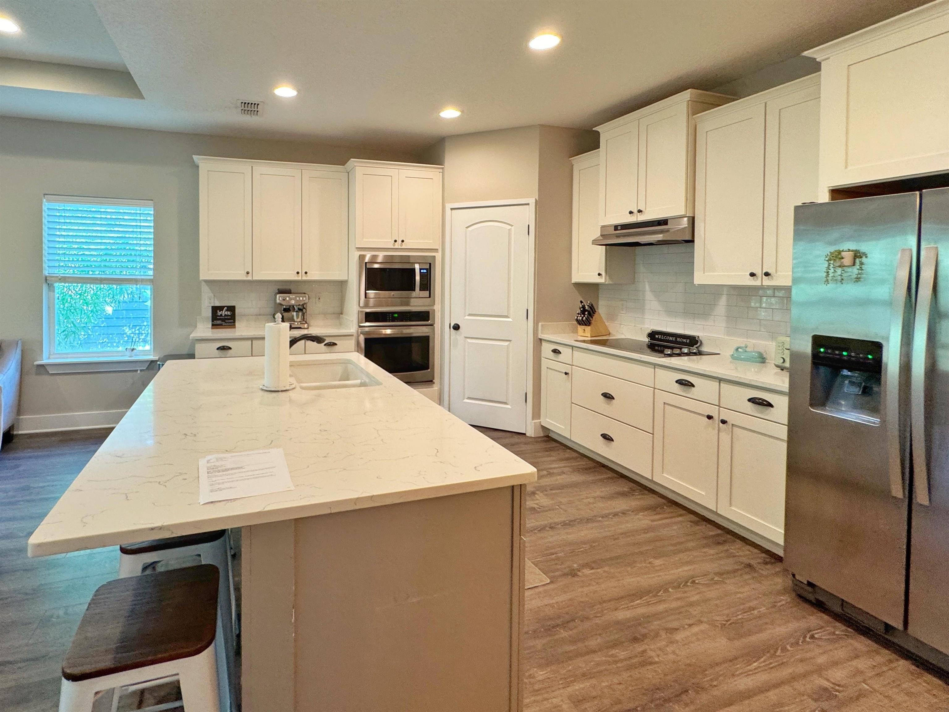 2523 Oleander Street St. Augustine, FL 32080 - Photo 9 of 54 a kitchen with stainless steel appliances a stove a sink a microwave and cabinets