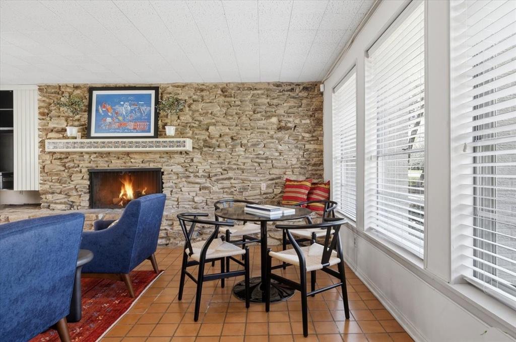 6321 Greenway Road Fort Worth, TX 76116 - Photo 20 of 40 Tiled dining room with a stone fireplace