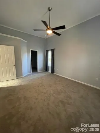 a view of an empty room with a fan