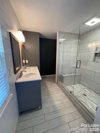 a bathroom with a mirror and a shower