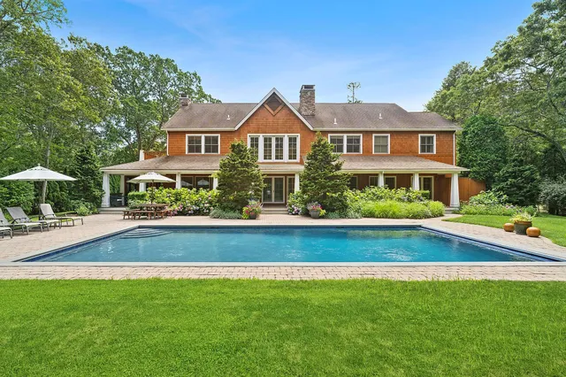 a front view of a house with a yard table and chairs
