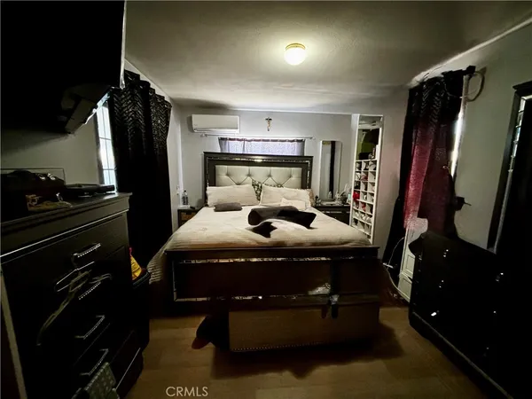 a bed sitting in a bedroom next to a window