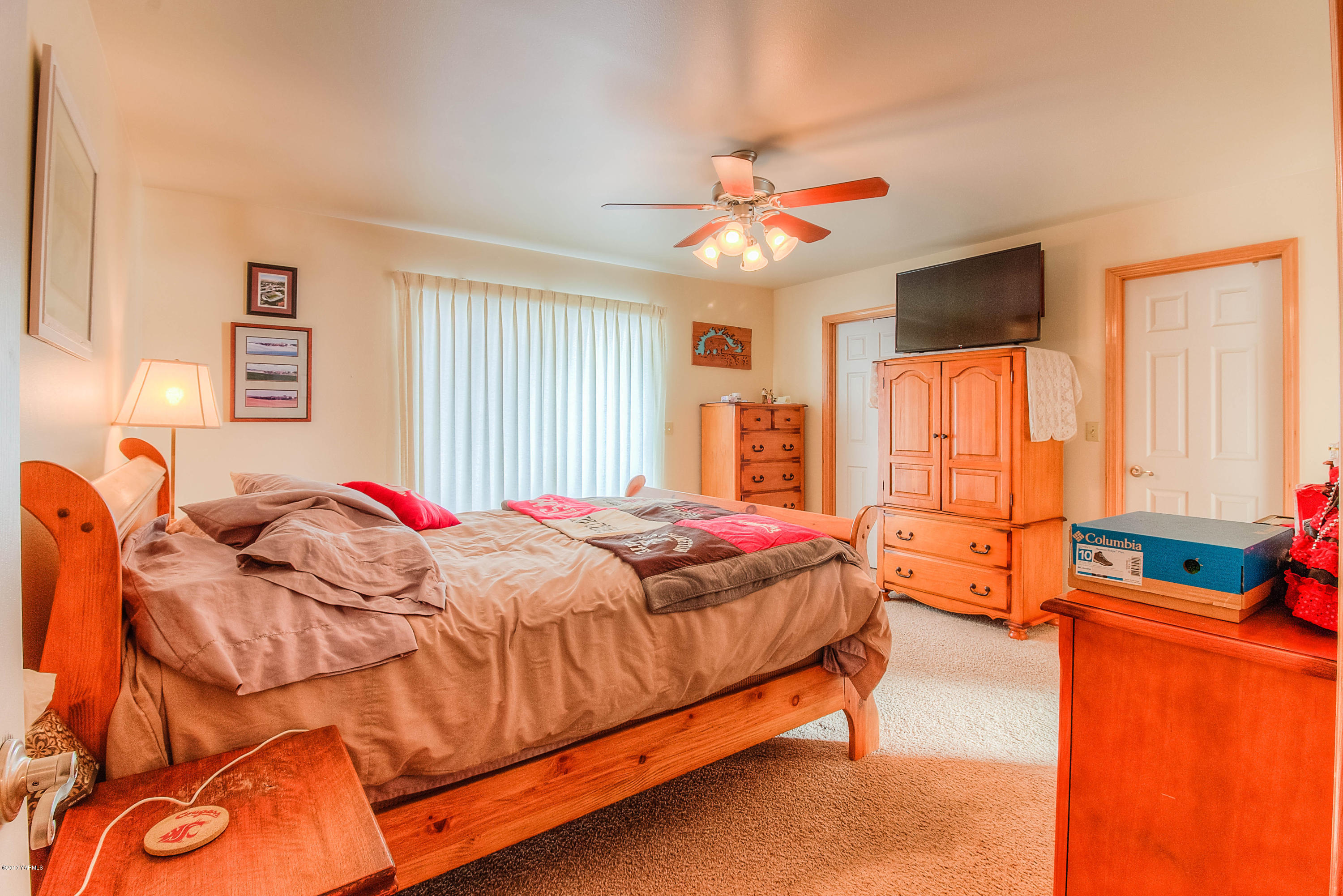205 Beane Road Moxee, WA 98936 - Photo 13 of 28 a bed room with a bed and a chandelier