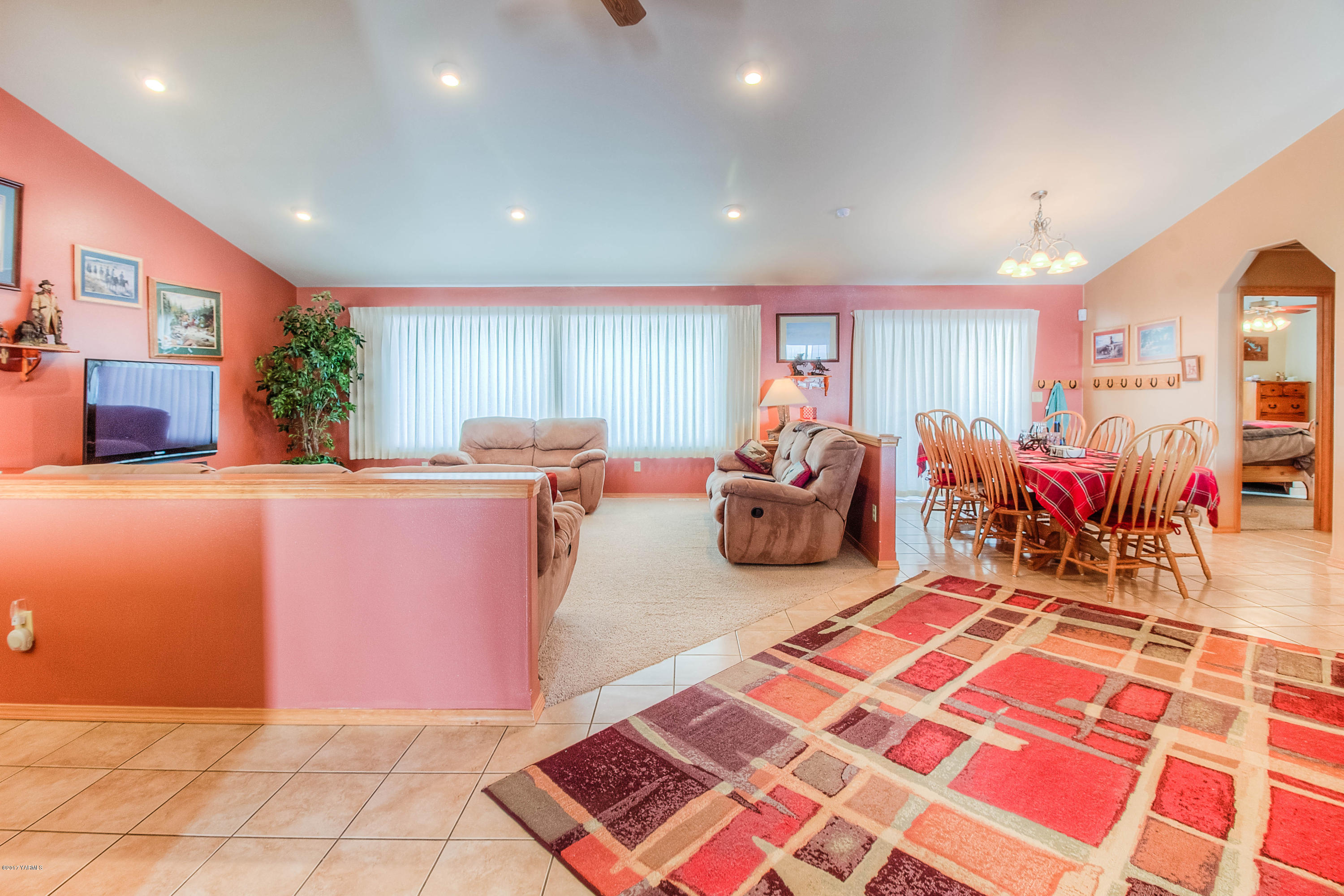 205 Beane Road Moxee, WA 98936 - Photo 6 of 28 a living room with furniture a rug kitchen view and a large window
