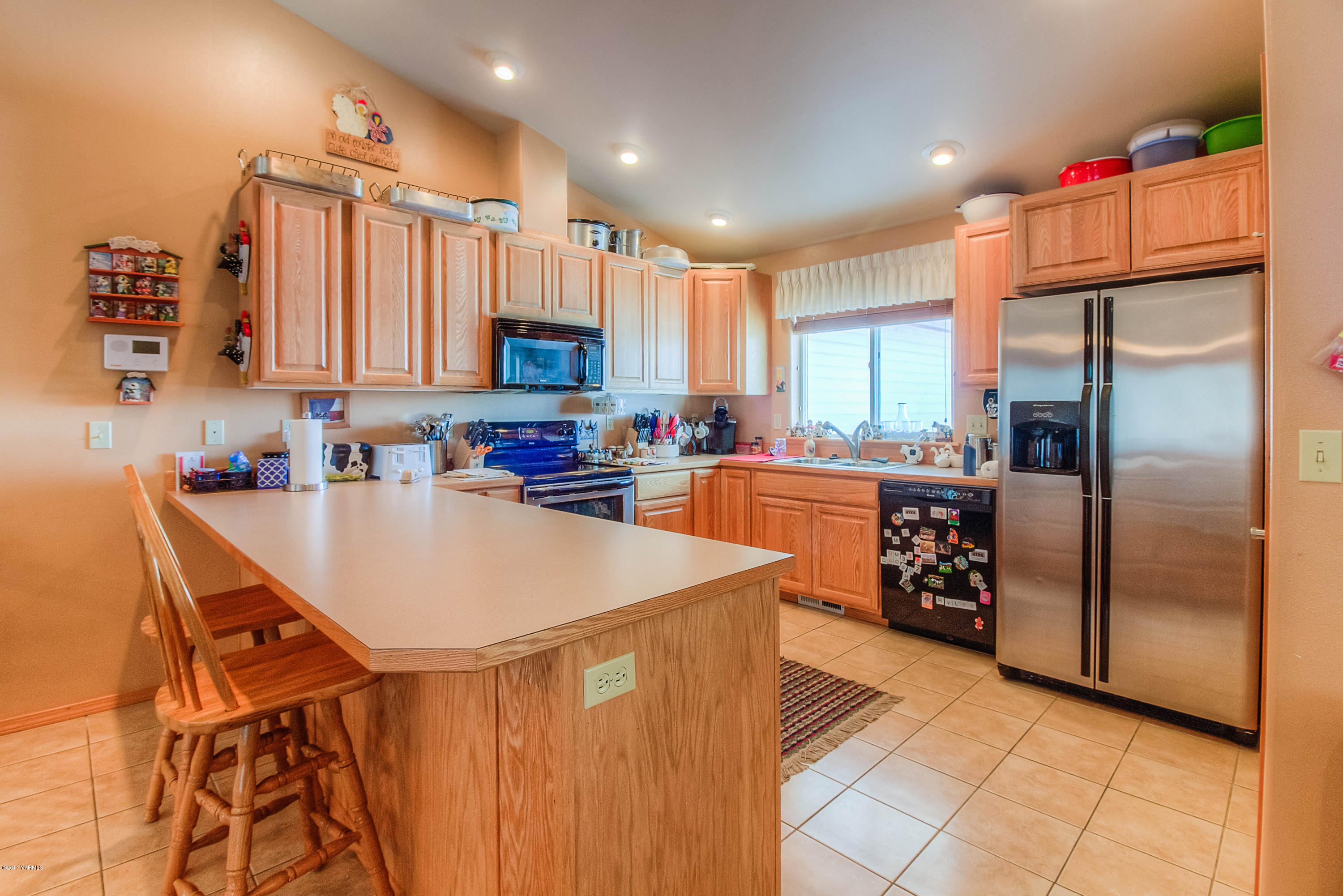 205 Beane Road Moxee, WA 98936 - Photo 10 of 28 a kitchen with stainless steel appliances granite countertop a refrigerator a sink a stove and a refrigerator