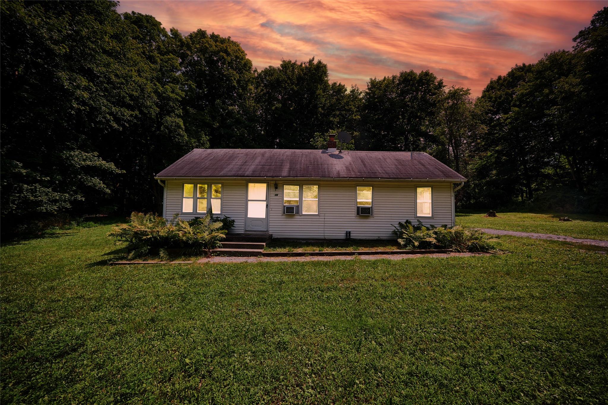 Ranch-style home with a yard and a porch