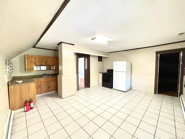 a view of kitchen with refrigerator and window