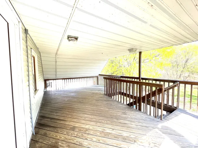 a view of a balcony with wooden floor