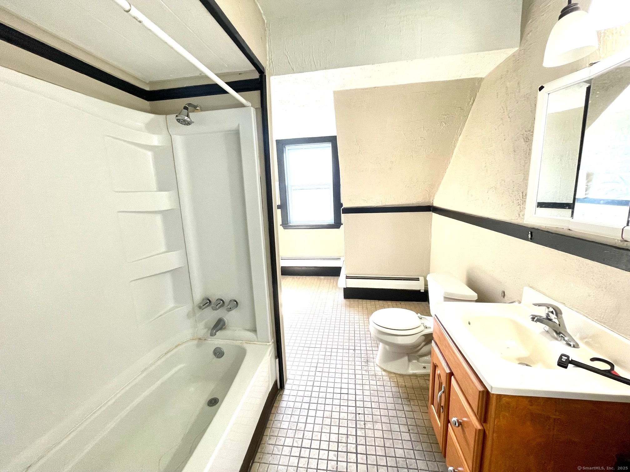 21 Elm Street Ansonia, CT 06401 - Photo 7 of 17 a bathroom with a bathtub shower sink vanity and toilet