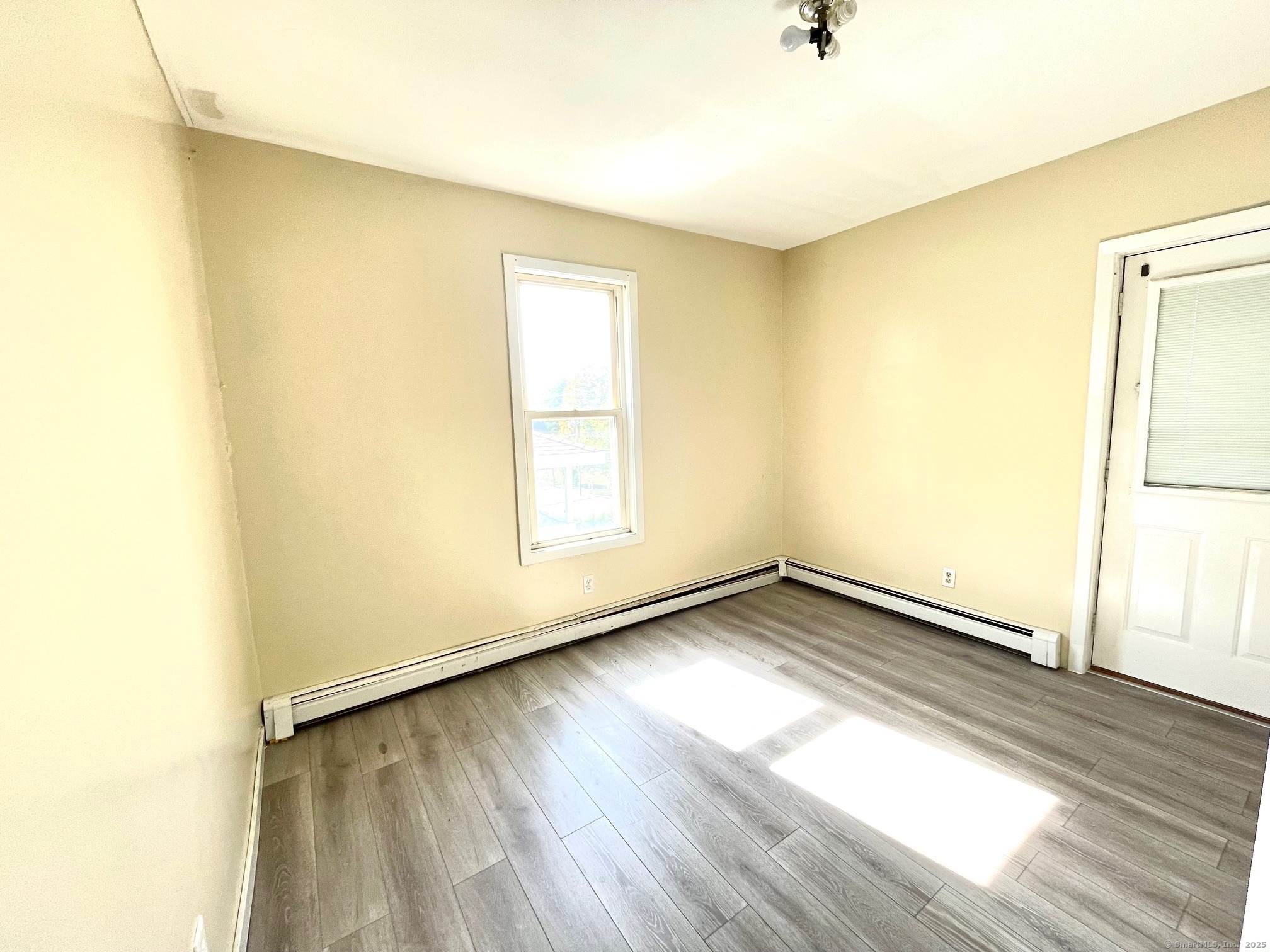 21 Elm Street Ansonia, CT 06401 - Photo 9 of 17 a view of a room with wooden floor and a window