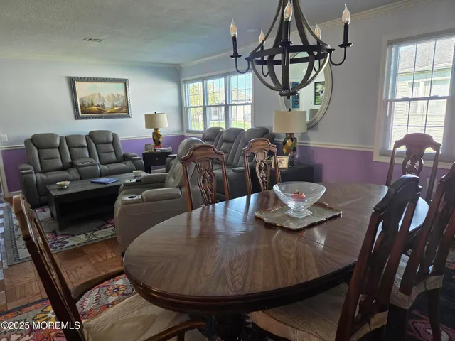 a living room with furniture a window and wooden floor